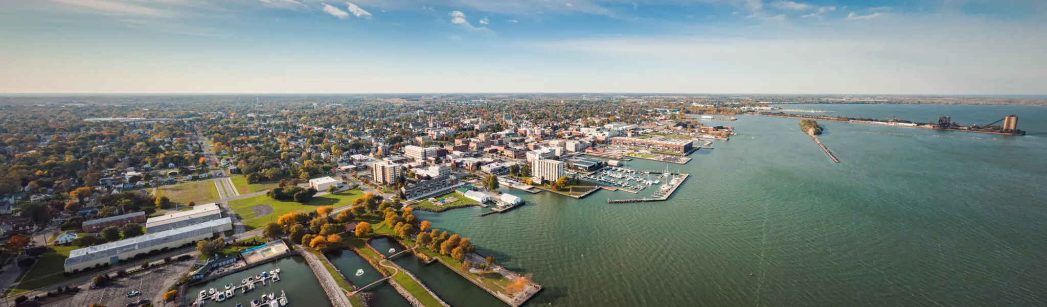 Aerial view of city along large waterfront marina